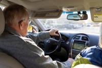 A photo shows Jim Maybach driving inside his car from behind.