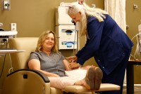A photo of a woman receiving an infusion at a medical clinic.